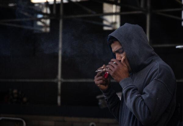 A man smokes fentanyl on the streets of San Francisco on March 7, 2024. (John Fredricks/The Epoch Times)