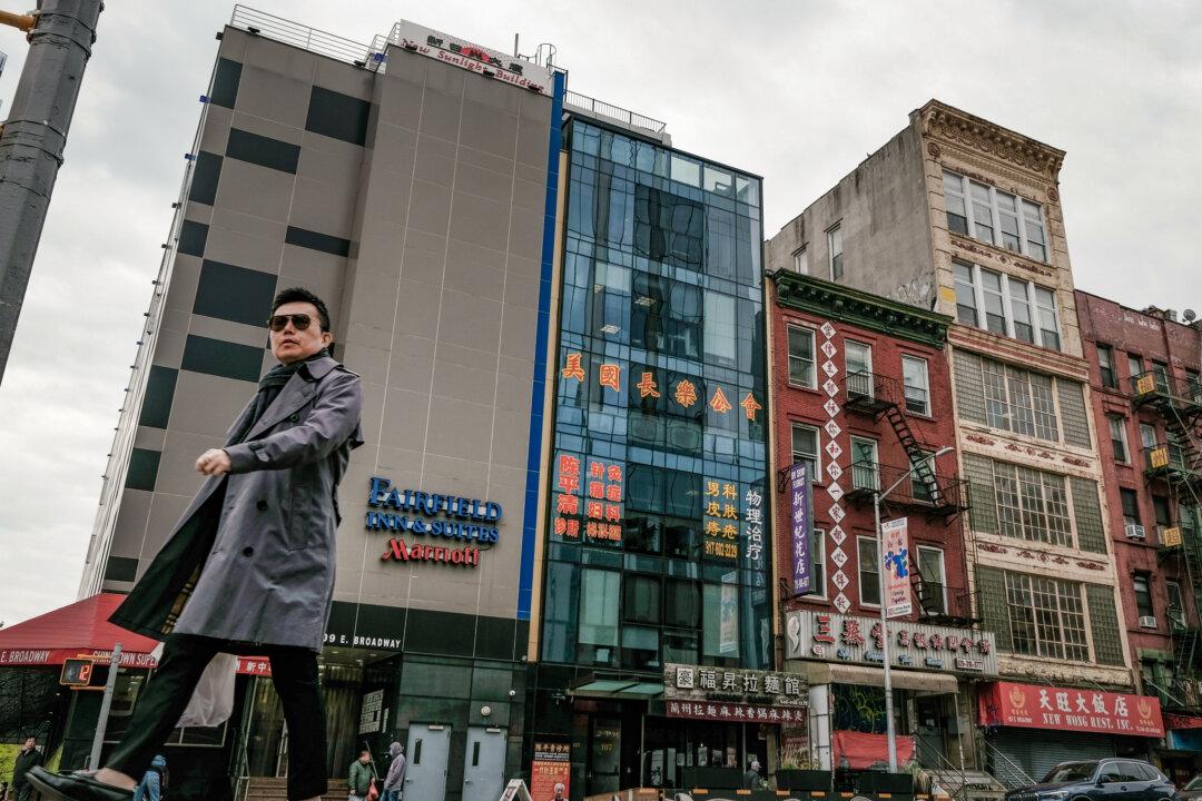 People walk by a building (C) that is suspected of being a Beijing-controlled secret police station used to repress dissidents living in the United States, in New York City's Chinatown on April 18, 2023. (Spencer Platt/Getty Images)