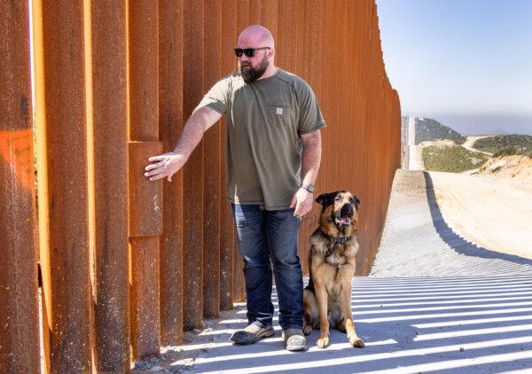 Cory Gautereaux and his dog look at a recent repair done along the United States border wall outside of Campo, Calif., on April 12, 2024. (John Fredricks/The Epoch Times)
