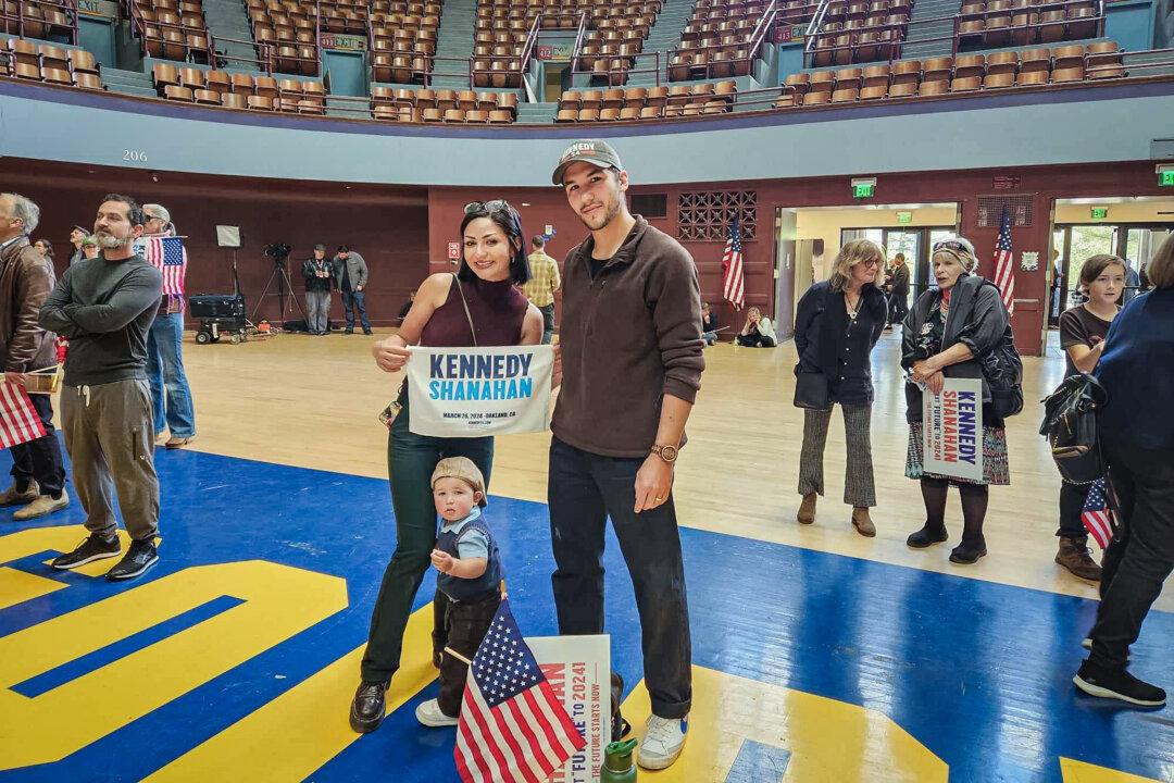 Anthony Martinez, his wife, Briana, and their 18-month-old son, attended the event where Robert F. Kennedy Jr. introduced Nicole Shanahan as his running mate, in Oakland, Calif., on March 26, 2024. (Jeff Louderback/The Epoch Times)