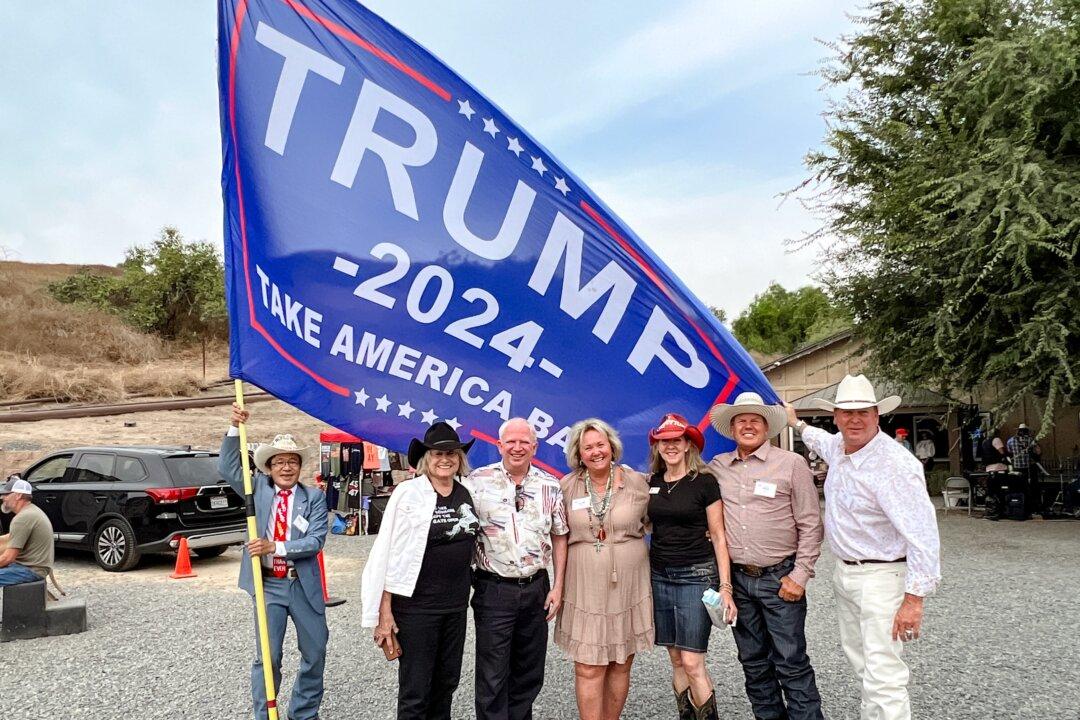 John Eastman (3rd L) and his supporters pose for a photo at a private event held at a ranch in northern Orange County, Calif., on Aug. 19, 2023. (Brad Jones/The Epoch Times)