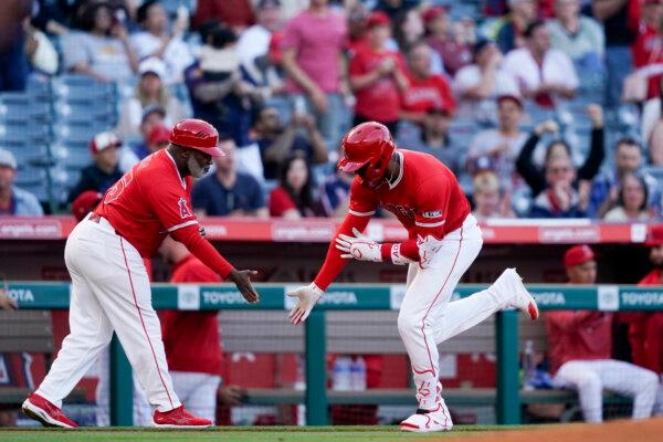 Jo Adell of the Angels celebrates his home run against the Phillies with third base coach Eric Young in Anaheim, Calif., on April 29, 2024. (Ryan Sun/AP Photo)