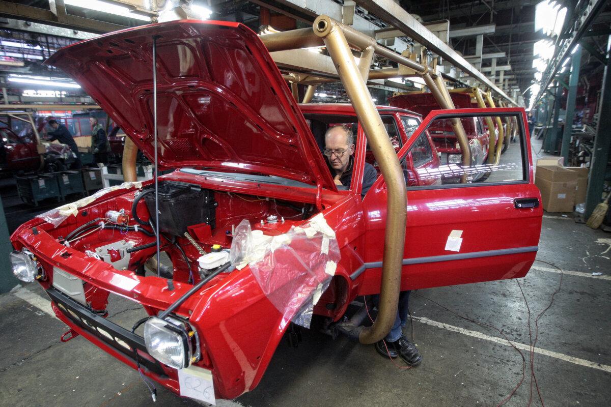 A man works on one of the last Yugos at Serbia's Zastava car plant on the production line in Kragujevac on Nov. 9, 2008. The car became popular in the local market because of its low price and fuel consumption. (Aleksandar Stankovic/AFP via Getty Images)