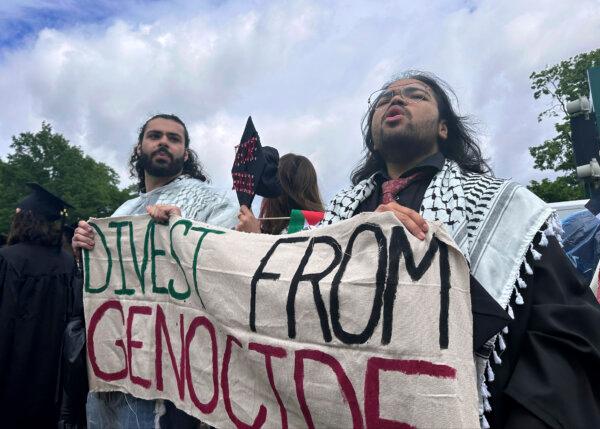 Pro-Palestian graduates leave an outdoor commencement at Massachusetts Institute of Technology in Cambridge, Mass., Thursday, May 30, 2024. (AP Photo/Michael Casey)