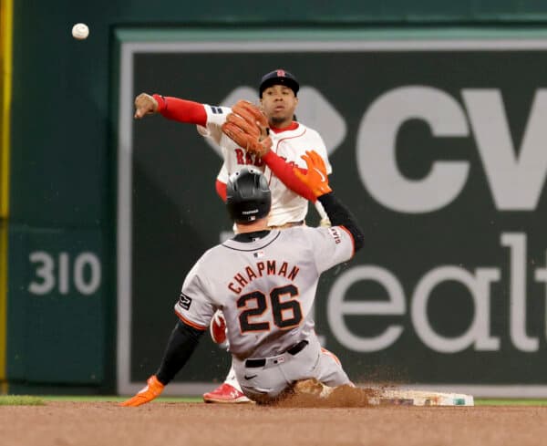 Red Sox second baseman Enmanuel Valdez throws over top of the Giants' Matt Chapman to complete a game-ending double play in Boston on May 1, 2024. (Mark Stockwell/AP Photo)