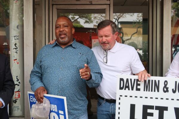 Bishop Gale Oliver Jr., left, says a prayer next to Orange County Board of Education trustee Ken Williams at a rally opposing SB 907  in Fullerton, Calif., on May 3, 2024. (Sophie Li/The Epoch Times)