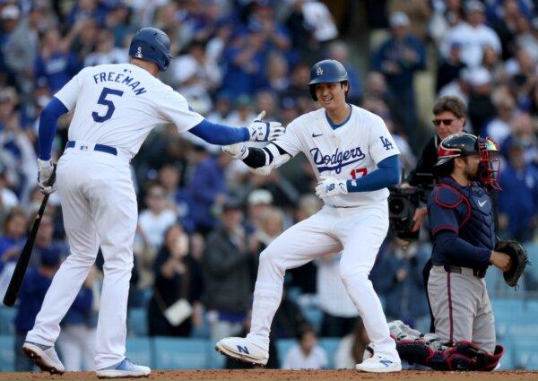 Shohei Ohtani (17) of the Los Angeles Dodgers celebrates his solo home run with Freddie Freeman (5) behind Travis d'Arnaud (16) of the Atlanta Braves, during the third inning in Los Angeles on May 4, 2024. (Harry How/Getty Images)
