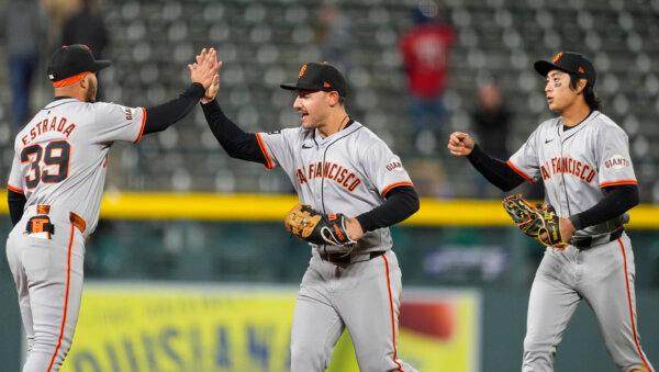 Thairo Estrada (L), Michael Conforto, and Jung Hoo Lee celebrate the Giants' 5-0 victory over the Rockies in Denver on May 7, 2024. (David Zalubowski/AP Photo)