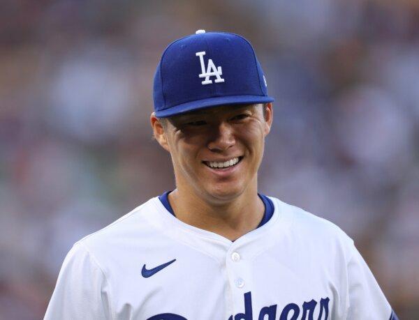 Yoshinobu Yamamoto (18) of the Los Angeles Dodgers smiles as he makes his way to the dugout before the start of the game against the Miami Marlins in Los Angeles on May 7, 2024. (Harry How/Getty Images)