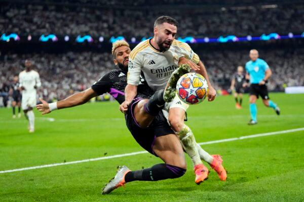 Bayern's Eric Maxim Choupo-Moting (L) fights for the ball with Real Madrid's Dani Carvajal during the Champions League semifinal second leg soccer match between Real Madrid and Bayern Munich at the Santiago Bernabeu stadium in Madrid on May 8, 2024. (Manu Fernandez/AP Photo)