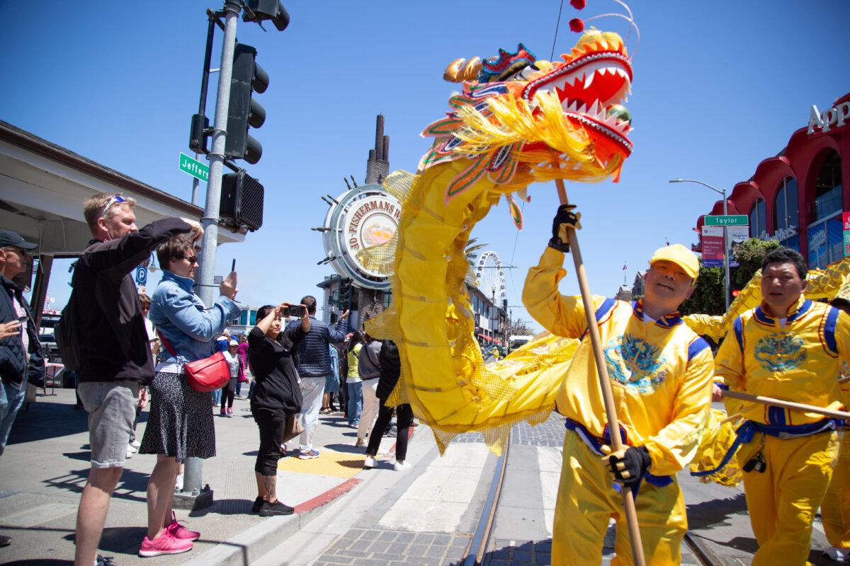 A golden dragon is part of the procession of the parade in San Francisco on May 11, 2024. (Lear Zhou/The Epoch Times)