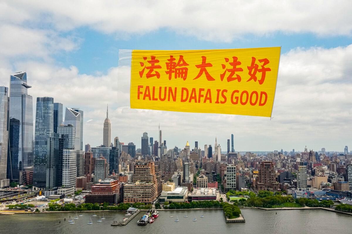 A banner reading “Falun Dafa Is Good” flies over the Hudson River in New York to mark the worldwide celebrations of the 32nd anniversary of Falun Dafa's public introduction, on May 13, 2024. (Larry Dye/The Epoch Times)