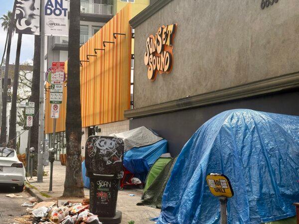 Homeless tents and blue tarps crowd the sidewalk outside the Sunset Sound Studio on May 14, 2024. (Jill McLaughlin / The Epoch Times)