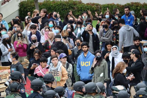 Police face-off with pro-Palestinian students and activists during a protest at the University of California–Irvine in Irvine, Calif., on May 15, 2024. (May He/The Epoch Times)