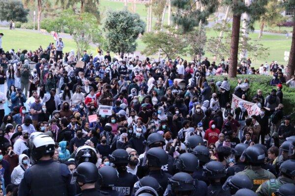 Police face-off with pro-Palestinian students and activists during a protest at the University of California–Irvine in Irvine, Calif., on May 15, 2024. (May He/The Epoch Times)