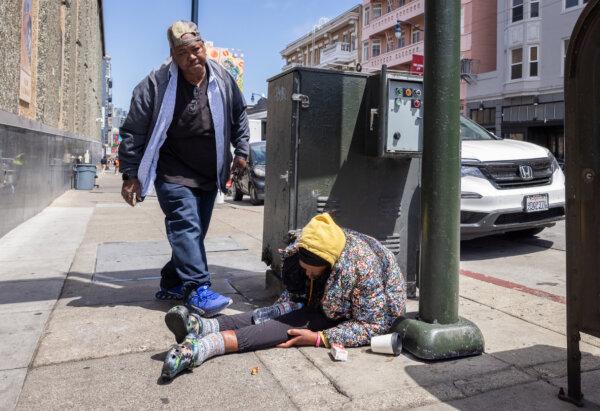 JJ Smith checks on the well-being of homeless drug addicts in the Tenderloin District of San Francisco, Calif., on May 16, 2024. (John Fredricks/The Epoch Times)