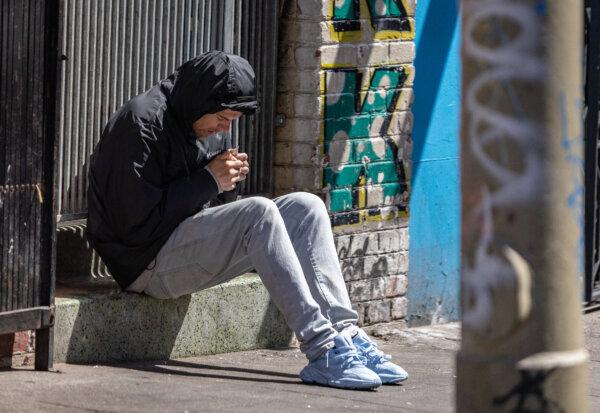 A man sits in the Tenderloin District of San Francisco, Calif., on May 16, 2024. (John Fredricks/The Epoch Times)