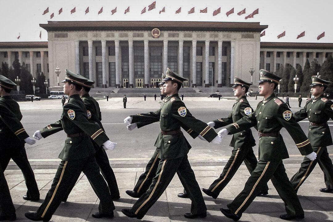 Chinese military police march on Tiananmen Square prior to the opening session of the Chinese People's Political Consultative Committee in Beijing on March 3, 2000. (Stephen Shaver/AFP via Getty Images)