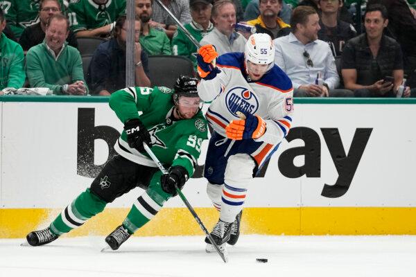 The Stars' Matt Duchene (L) and Dylan Holloway of the Oilers eye a loose puck during Game 1 of the NHL Western Conference final in Dallas on May 23, 2024. (Tony Gutierrez/AP Photo)