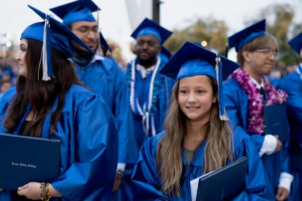 Athena Elling stands alongside her fellow graduates at the Irvine Valley College Commencement in Irvine, Calif., on May 23, 2024. (Sophie Li/The Epoch Times)