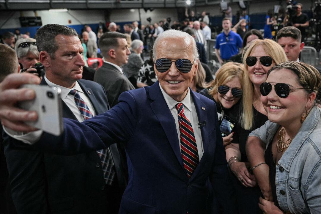 President Joe Biden takes a selfie with supporters at a YMCA in Nashua, N.H., on May 21, 2024. (Mandel Ngan/AFP via Getty Images)
