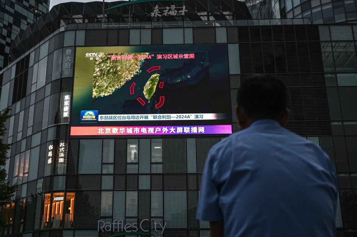 An outdoor screen shows a news coverage of China's military drills around Taiwan, in Beijing on May 23, 2024. (Jade Gao/AFP via Getty Images)