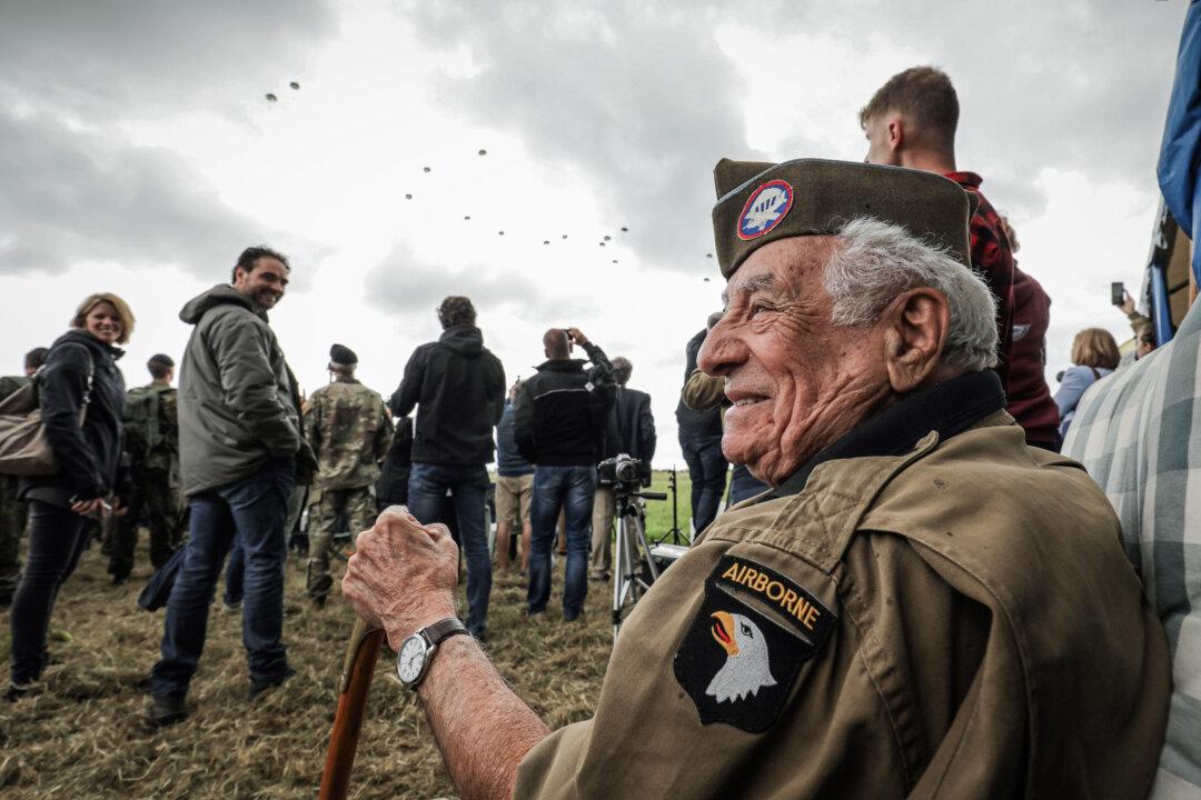 U.S. paratrooper veteran Vincent Speranza watches a parachute drop from seven C-47 aircraft over Carentan in Normandy, France, on June 5, 2019. (Ludovic Marin/AFP via Getty Images)