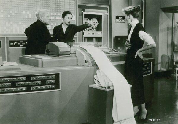Publicity still of (L-R) Spencer Tracy, Neva Patterson, and Katharine Hepburn in "Desk Set" from 1957. (MovieStillsDB)