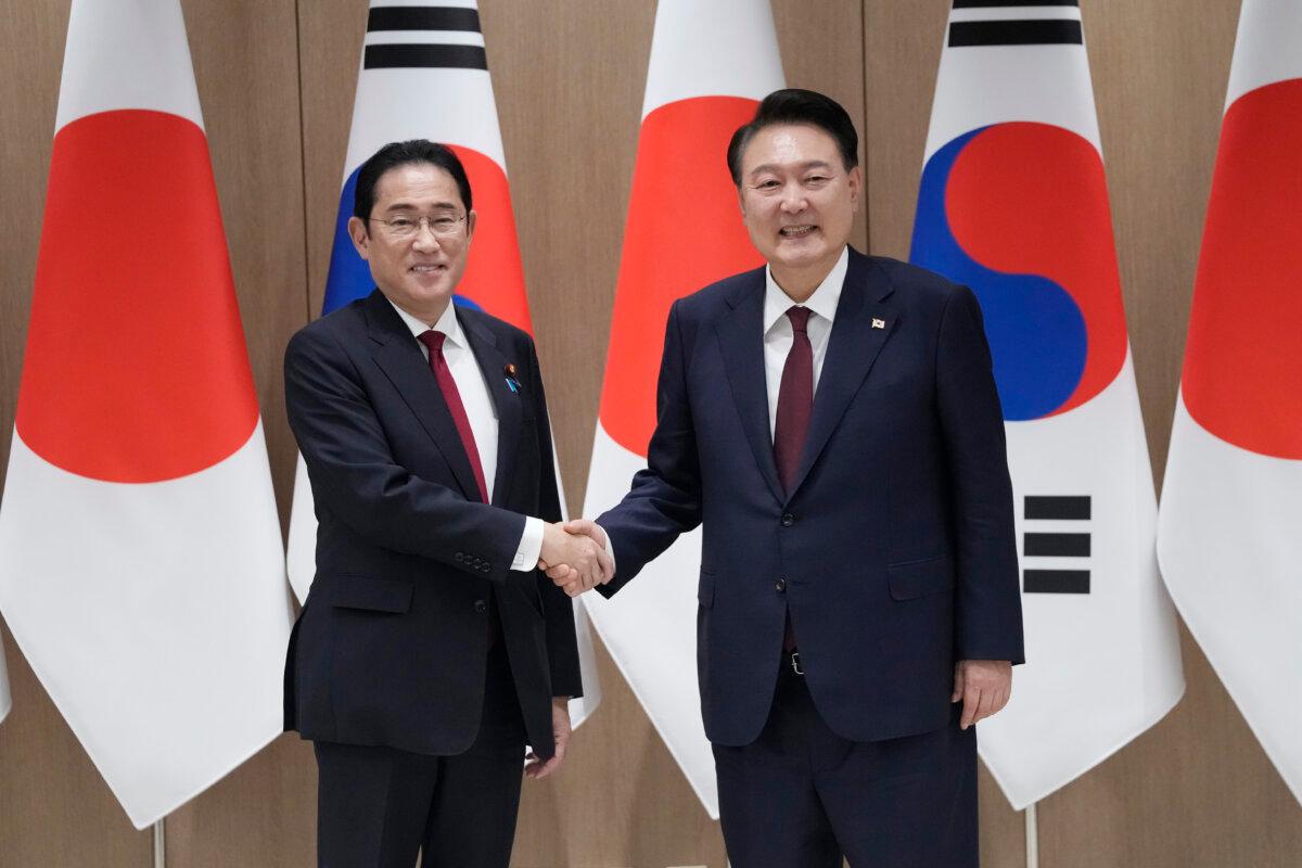 South Korean President Yoon Suk Yeol (R) shakes hands with Japanese Prime Minister Fumio Kishida (L) prior to a bilateral meeting at Presidential Office in Seoul, South Korea on May 26, 2024. (Ahn Young-Joon/Pool/Getty Images)