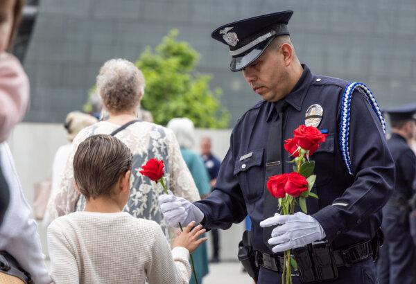 Roses were handed to those who attended the memorial service at LAPD Headquarters in Los Angeles on May 28, 2024. (John Fredricks/The Epoch Times)