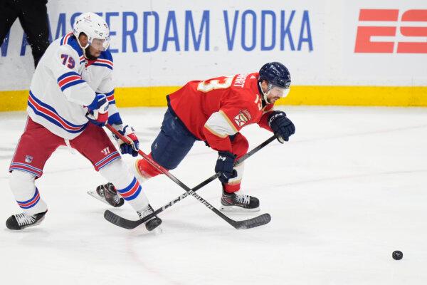 Rangers defenseman K'Andre Miller (L) and Sam Reinhart of the Panthers tangle during Game 4 of the NHL Eastern Conference final in Sunrise, Fla., on May 28, 2024. (Wilfredo Lee/AP Photo)