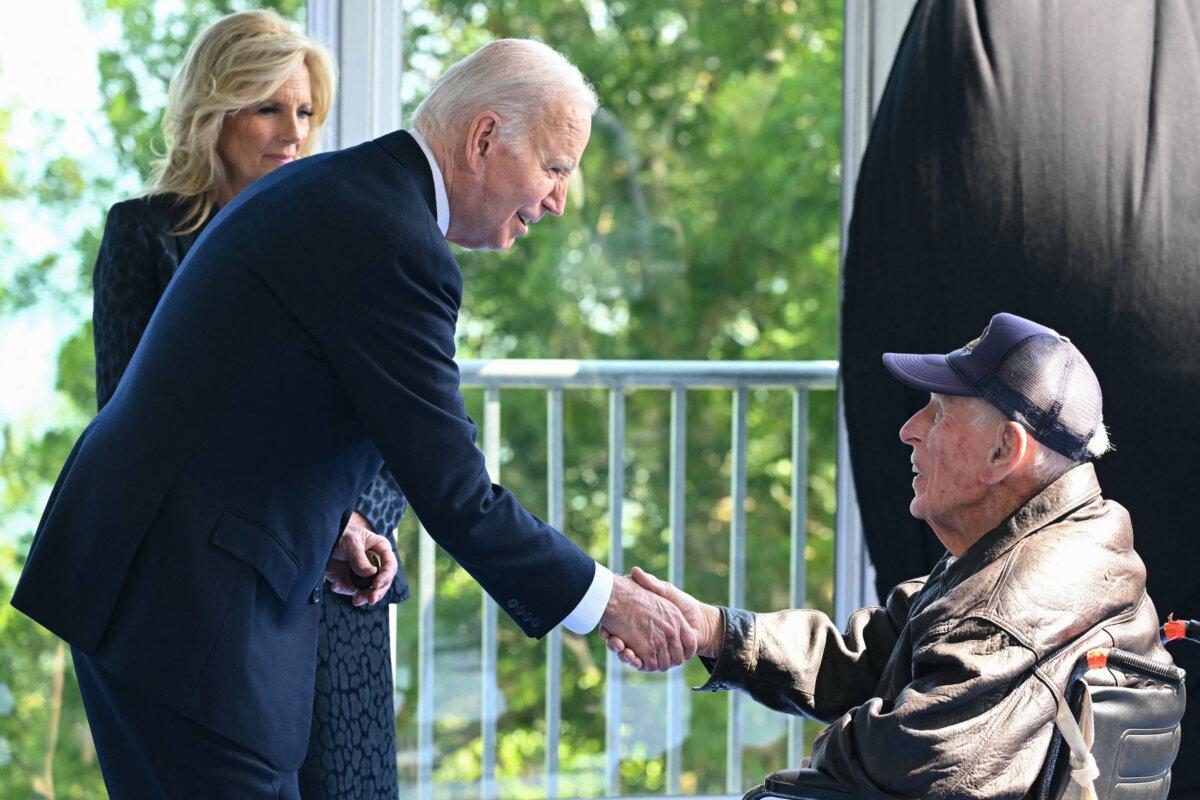 President Joe Biden and First Lady Jill Biden speak with a U.S. World War II veteran as they attend the U.S. ceremony marking the 80th anniversary of the D-Day Allied landings in Normandy, France, on June 6, 2024. (Saul Loeb/AFP)