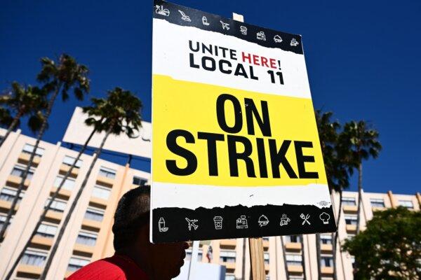 People hold signs in support of striking hotel workers with United Here Local 11 outside of the Four Points by Sheraton hotel at Los Angeles International Airport (LAX) in Los Angeles, California on July 11, 2023. (Patrick T. Fallon/AFP via Getty Images)