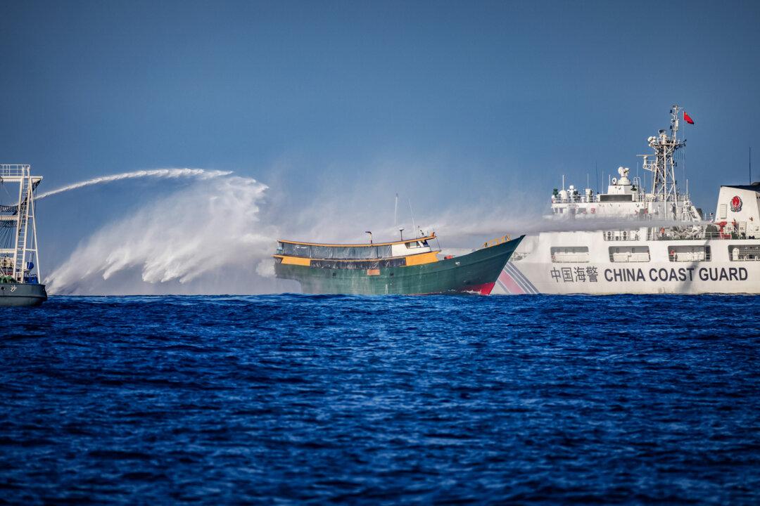 Chinese Coast Guard ships fire water cannons at a Philippine Navy chartered vessel conducting a routine resupply mission to troops stationed at Second Thomas Shoal, in the South China Sea, on March 5, 2024. (Ezra Acayan/Getty Images)