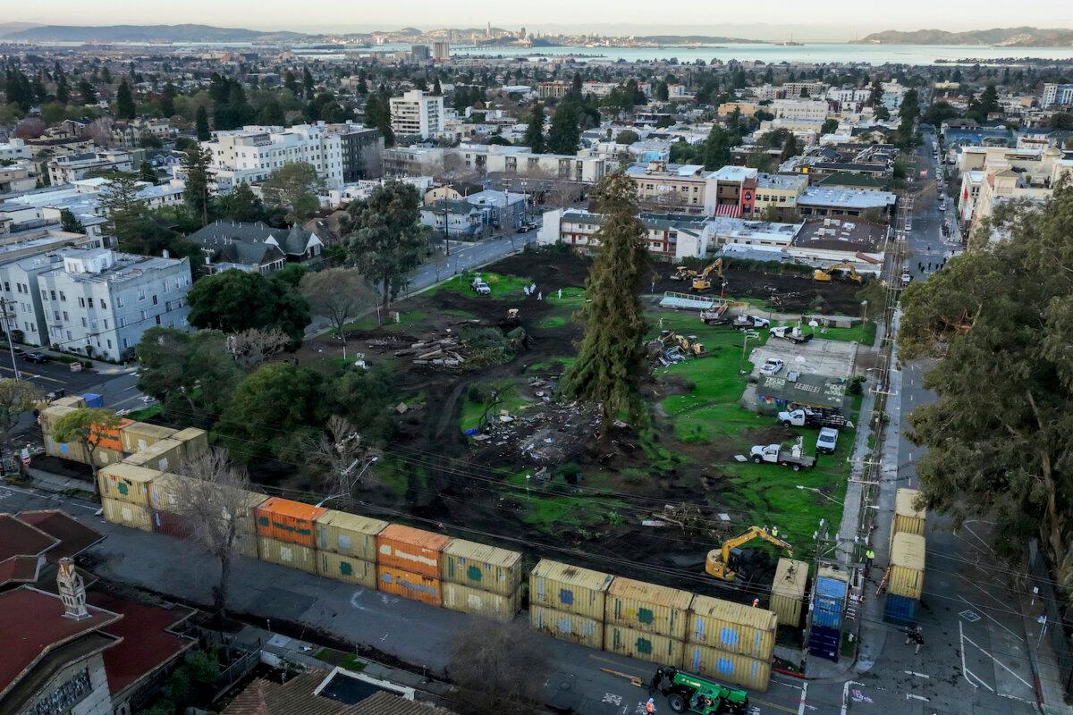 Stacked shipping containers begin to surround People's Park in Berkeley, Calif. on Thursday, Jan. 4, 2024. (Brontë Wittpenn/San Francisco Chronicle via AP)