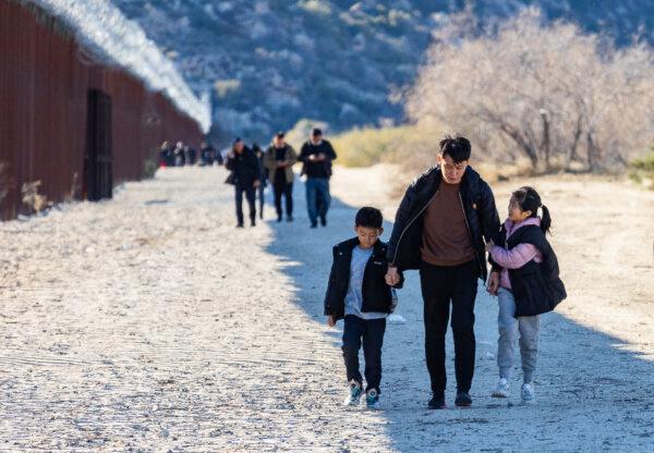 Chinese illegal immigrants walk to Willow Camp before being processed by Border Patrol agents in Jacumba, Calif., on Dec. 6, 2023.  The online poll found concerns about immigration are more prominent among Republicans. (John Fredricks/The Epoch Times)