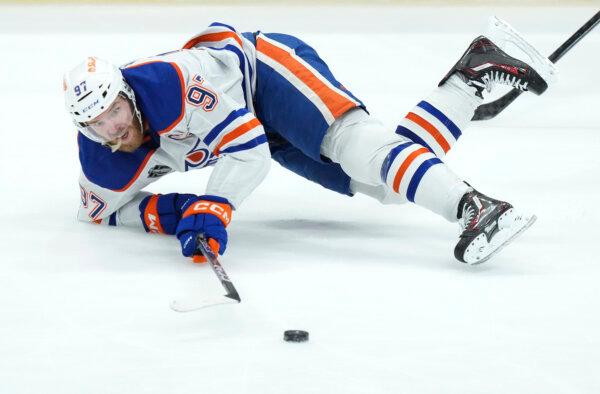 Oilers center Connor McDavid goes down after being tripped during Game 2 of the Stanley Cup Final against the Panthers in Sunrise, Fla., on June 10, 2024. (Nathan Denette/The Canadian Press via AP)