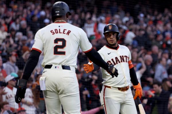 Jorge Soler receives a greeting from Giants teammate Thairo Estrada after scoring a run against the Astros in San Francisco on June 10, 2024. (Jed Jacobsohn/AP Photo)