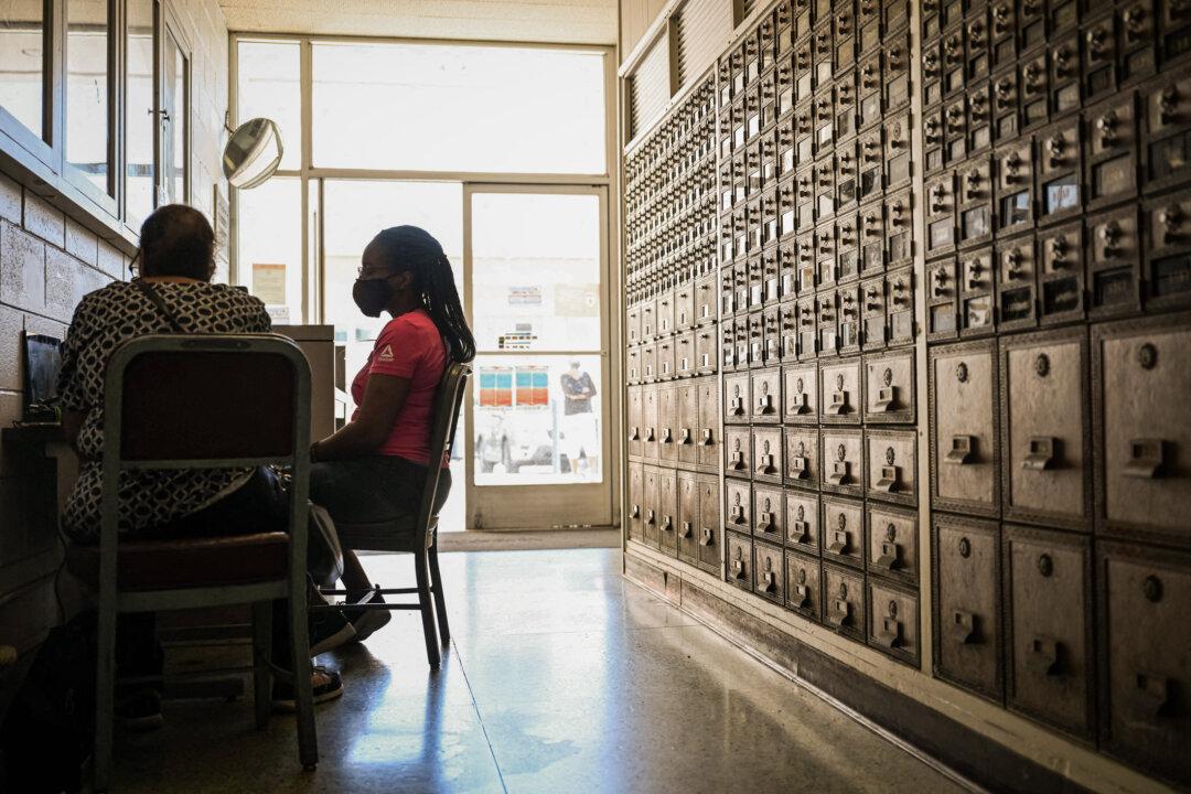 A job seeker fills out an application on a laptop during a job fair at a post office in Inglewood, Calif., on July 18, 2022. Tech companies, recruiters, and staffing agencies are among the biggest ghost posters, according to the CEO of a resume-building service. (Patrick T. Fallon/AFP via Getty Images)