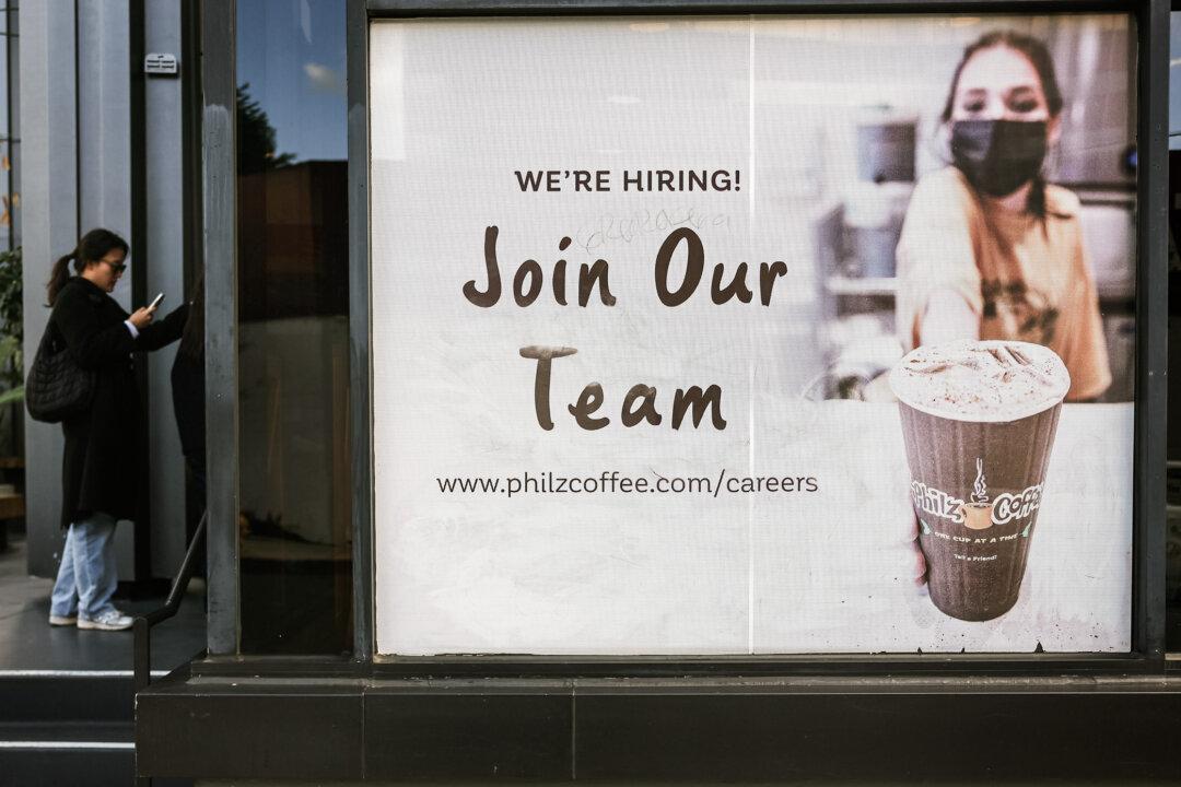 A “We're Hiring” sign is posted outside a coffee shop in Los Angeles on Jan. 3, 2024. Workforce intelligence company Revelio Labs observed that applicant ghosting has more than doubled in the past five years. (Mario Tama/Getty Images)