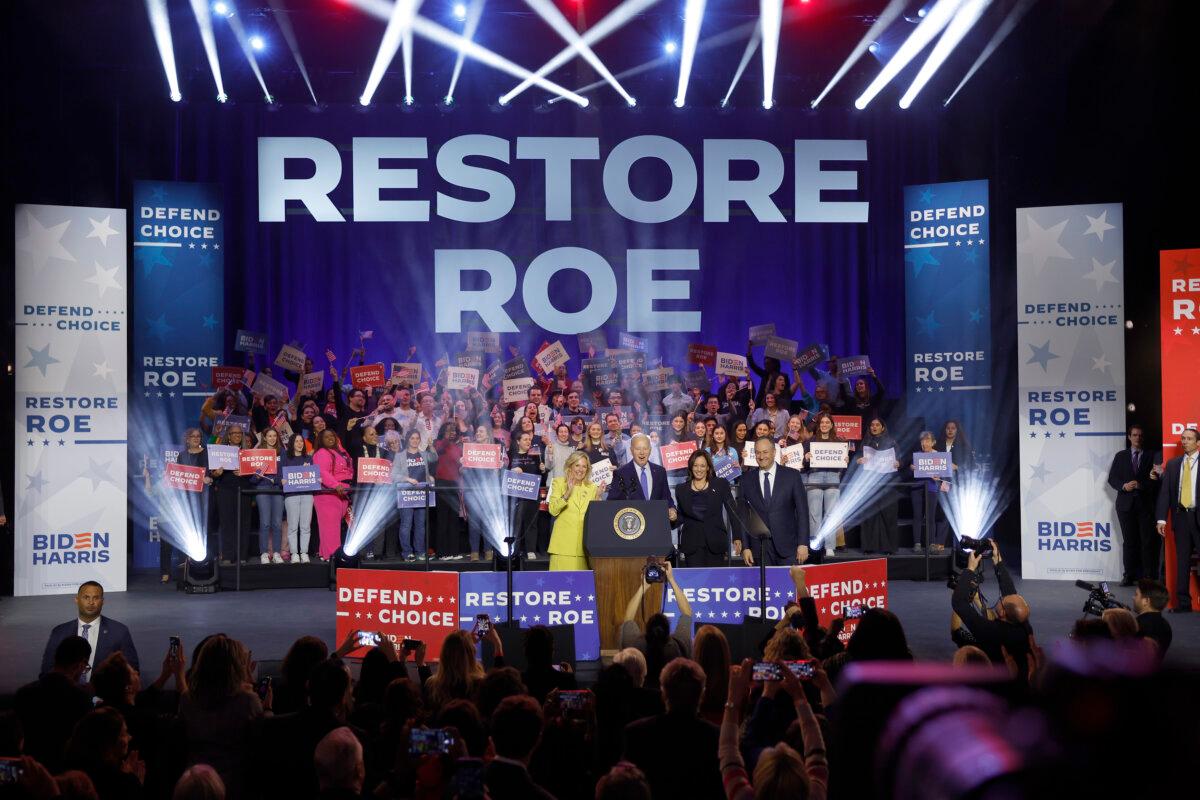 (L–R) First lady Jill Biden, President Joe Biden, Vice President Kamala Harris, and second gentleman Douglas Emhoff join hands at a rally in Manassas, Va., on Jan. 23, 2024. (Anna Moneymaker/Getty Images)