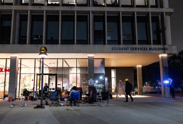 Pro-Palestinian protesters block the entrance of the California State University Los Angeles (CSULA) Student Services Building in Los Angeles on June 12, 2024. Pro-Palestinian protesters barricaded the building where the administration of Cal State Los Angeles is located, prompting CSULA to issue a shelter-in-place order for employees still inside the building. (Etienne Laurent/AFP via Getty Images)