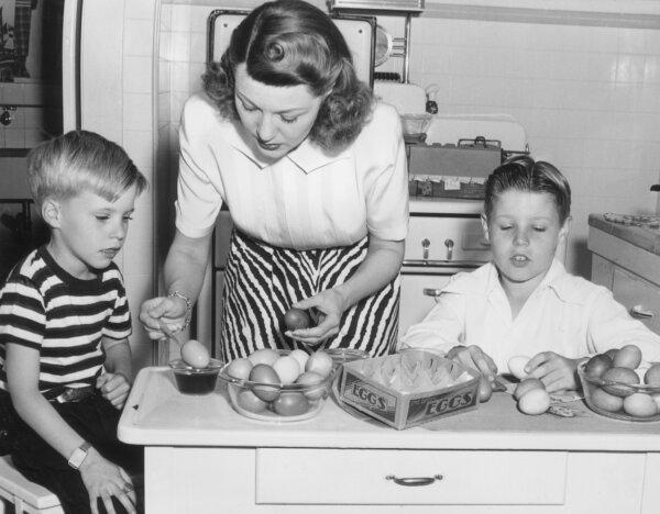 American actor Harriet Hilliard Nelson, of the television show "Ozzie and Harriet," shows her sons, future singer Ricky Nelson (left) and future director David Nelson, how to dye Easter eggs, circa 1947. (Hulton Archive/Getty Images)