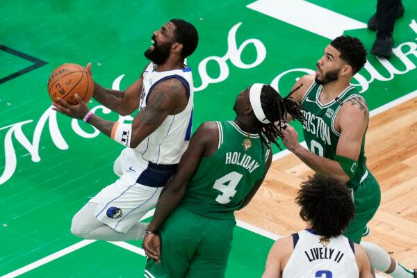 The Mavericks' Kyrie Irving takes the ball to the basket against the Celtics in Game 5 of the NBA Finals in Boston on June 17, 2024. (Michael Dwyer/AP Photo)