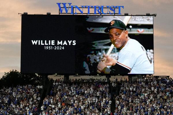 Wrigley Field fans observe a moment of silence for Hall of Famer Willie Mays during the Giants-Cubs game in Chicago on June 18, 2024. (Nam Y. Huh/AP Photo)