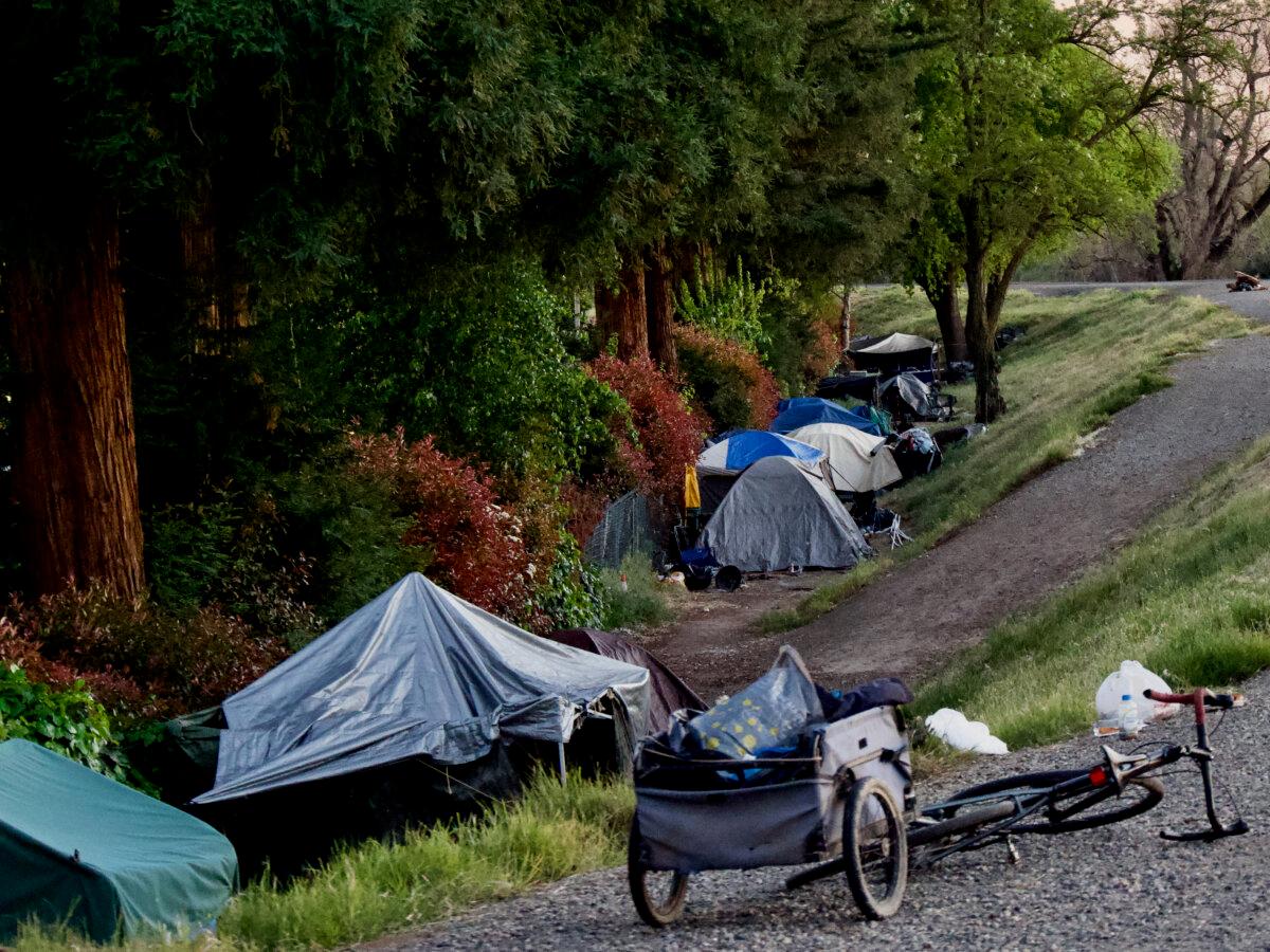 A homeless camp near Jibboom Street behind a motel in Sacramento, as seen on April 8, 2024, before it was swept by local authorities. (Travis Gillmore/The Epoch Times)