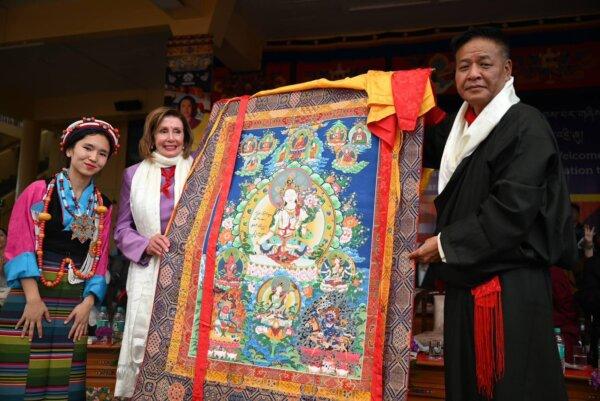 A traditional Tibetan scroll or thangka is presented to former U.S. Speaker of the House Nancy Pelosi (D-Calif.) during the visit of a congressional delegation to the 14th Dalai Lama, in Dharamshala, India, on June 18, 2024. (Central Tibetan Administration)