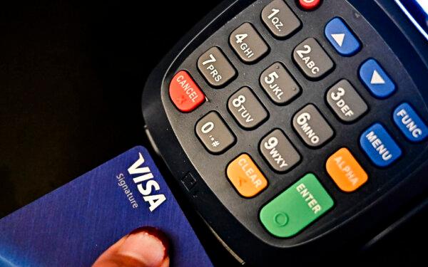 A credit card is placed into a credit card machine for processing payments in La Puente, Calif., on Sept. 11, 2023. (Frederic J. Brown/AFP via Getty Images)