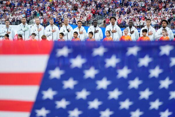 Players of United States stand during the national anthem prior to a Copa America Group C soccer match against Bolivia in Arlington, Texas, on June 23, 2024. (Julio Cortez/AP Photo)