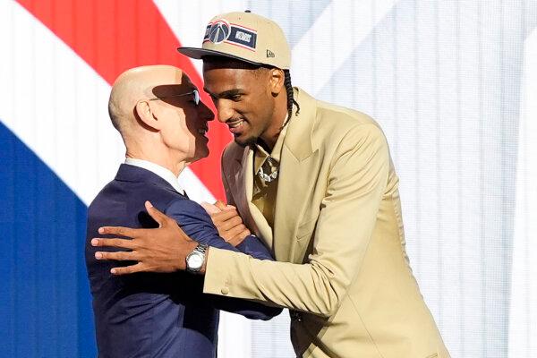 Alex Sarr (R) of France greets NBA Commissioner Adam Silver after being the second pick, by the Washington Wizards, in the NBA draft in New York on June 26, 2024. (Julia Nikhinson/AP Photo)
